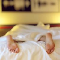 person in bed sleep apnoea