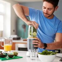 A man creating healthy shake for breakfast